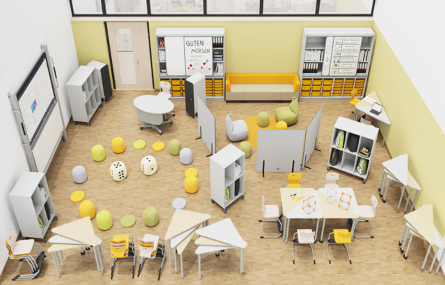 Draufsicht eines Klassenraums mit gruppierten oder beiseitegestapelten Dreieckstischen, abgeschirmter Leseecke und Kreis aus Sitzkissen